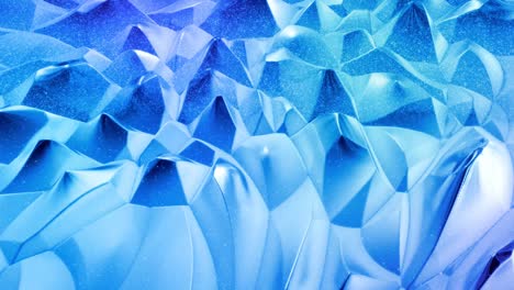 looped abstract liquid background with wavy sparkling pattern on shiny glossy surface. viscous blue fluid like surface of foil or brilliant glass. beautiful creative festive backdrop. simple bright bg