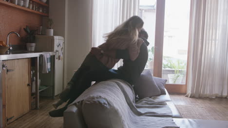 cheerful-young-couple-playfully-falling-onto-sofa-having-fun-romantic-relationship-embracing-enjoying-happy-lifestyle-together-at-home