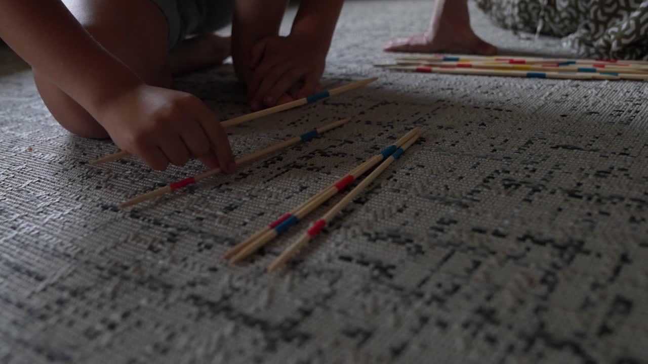 Child playing pick up sticks