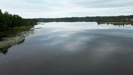 Still,-glass-like-water-in-early-fall-over-Little-Black-Lake