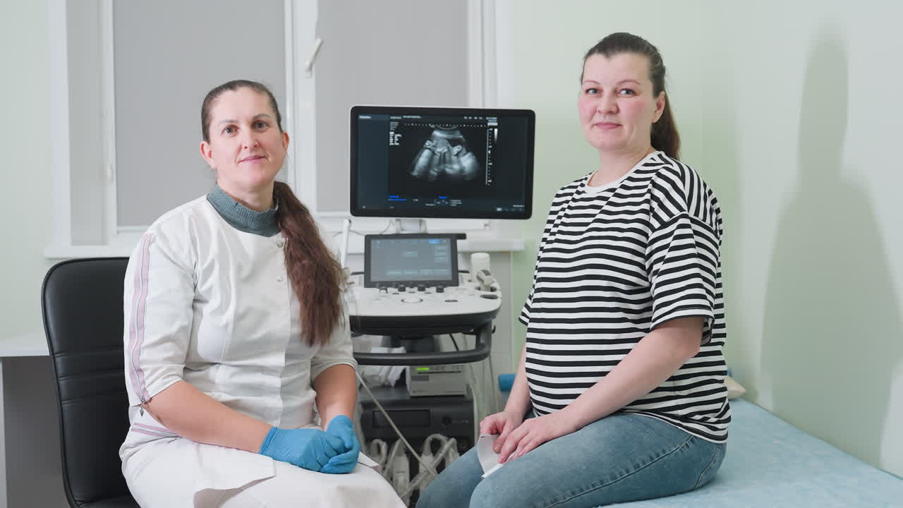 Medical practitioner and her patient seated in the consulting room, turning to look toward the entrance door, indicating a shift in focus during their session in a clinical environment