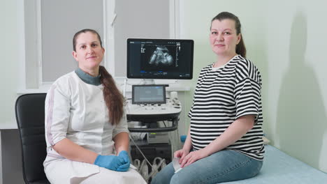 medical practitioner and her patient seated in the consulting room, turning to look toward the entrance door, indicating a shift in focus during their session in a clinical environment
