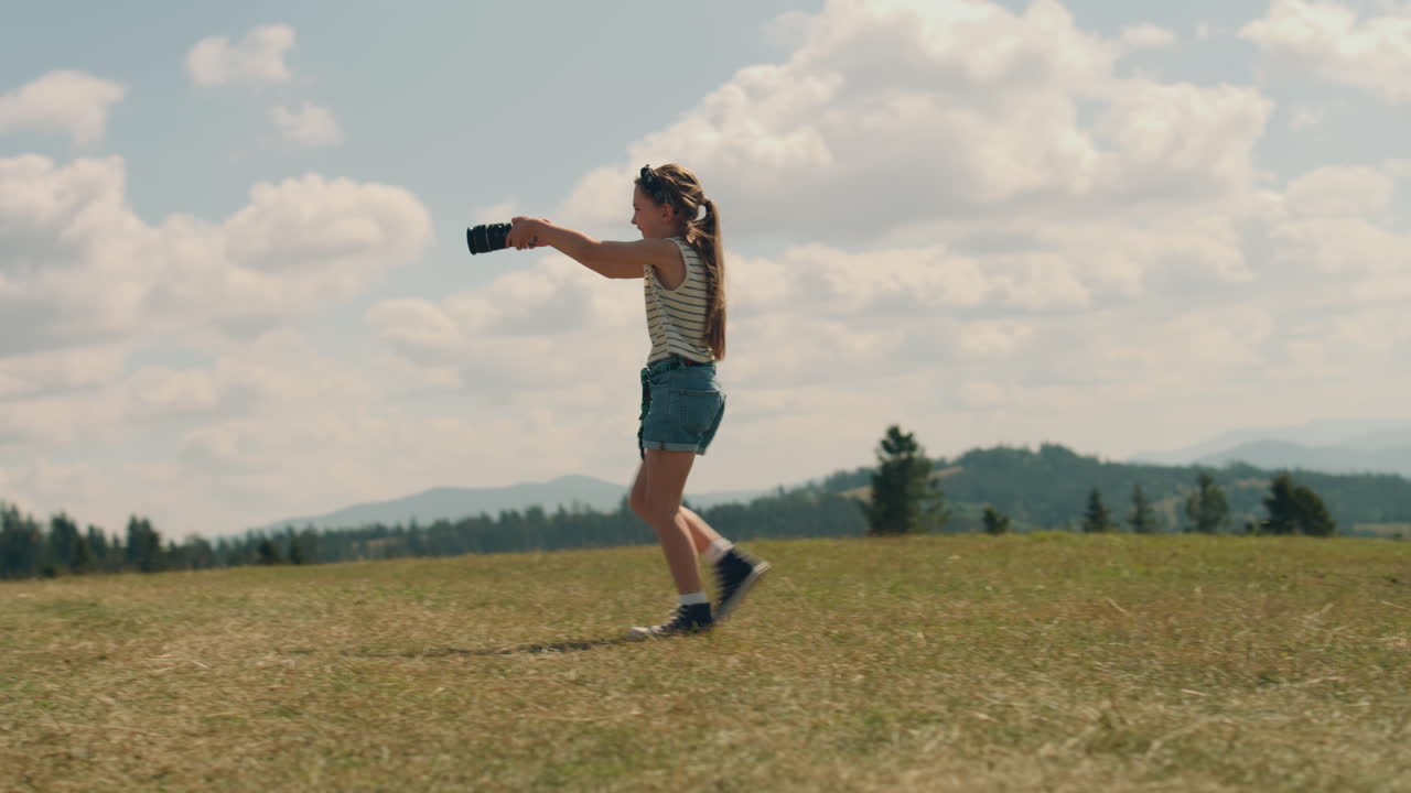 Young Girl Photographer Filming Movie Young Photographer Filming Beautiful Movie Using Digital Camera Girl Creating Content in Motion Wathing Results and Feeling Happy Spending Leisure Time Outdoor