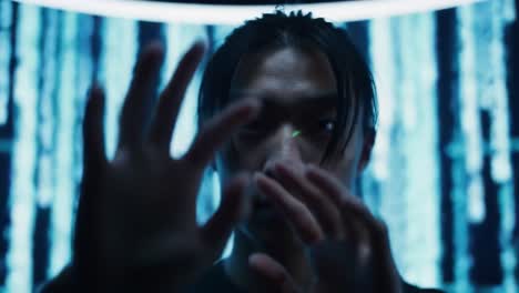a young man manipulating light patterns in a digital environment, surrounded by glowing screens and abstract visuals, showcasing innovative technology and creativity