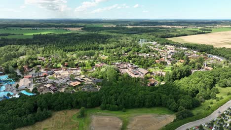 Panoramic-high-angle-aerial-view-of-Djurs-sommarland-amusement-park-in-Denmark---60-fps