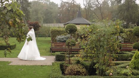 Lovely-newlyweds-caucasian-bride-meeting-groom-with-bouquet-in-park-making-kiss,-wedding-couple