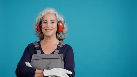 senior woman in work clothes and safety gear