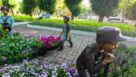 park garden scene with statues and flowers