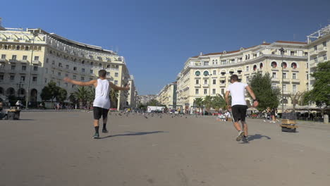 Two-guys-doing-acrobatic-tricks-outdoors