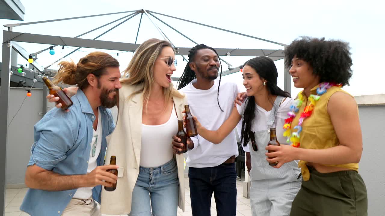 Friends celebrating with beer on a rooftop party