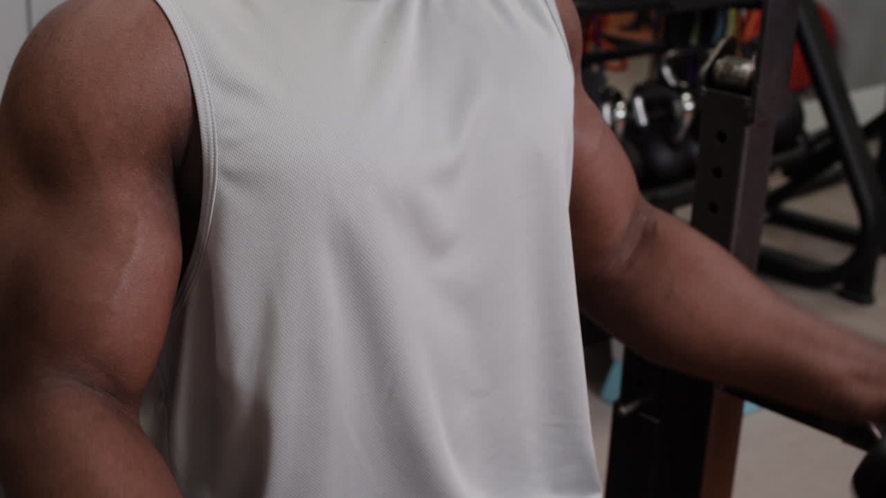 Man Working Out with Dumbbells in Gym