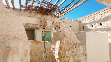 old house with a well in the middle of the desert