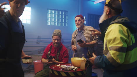 workers relaxing with beer and snacks in a workshop