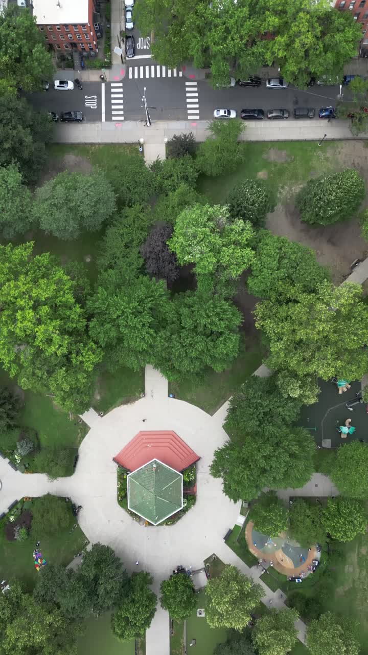 Aerial top-down drone shot of Liberty State Park in Jersey City. Gazebo centered in symmetrical park design with lush trees and walkways