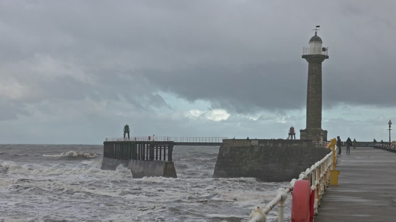 Wide-angle shot of storm waves rolling through Whitby Harbour