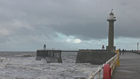 wide-angle shot of storm waves rolling through whitby harbour