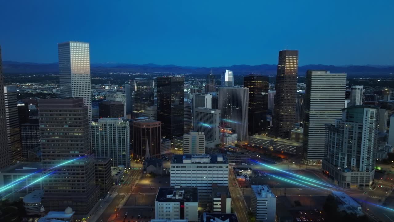 Blue-hour aerial view of a modern city skyline enhanced with glowing digital light trails that represent data flow, connectivity, and futuristic telecom networks across an urban environment
