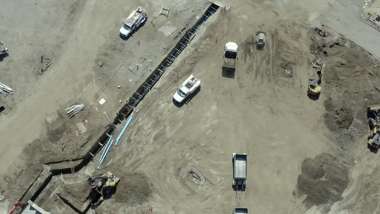 Large commercial real estate construction project, ground crew, aerial birds eye view