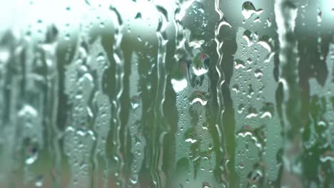 a captivating view through a rain-drenched window, showcasing the intricate patterns of water droplets on a glass surface amidst a natural backdrop