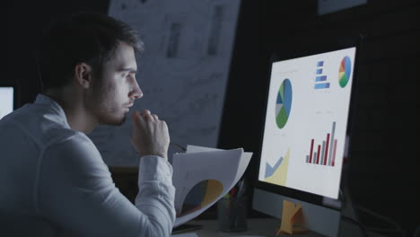 concentrated business man analyzing financial document in night office