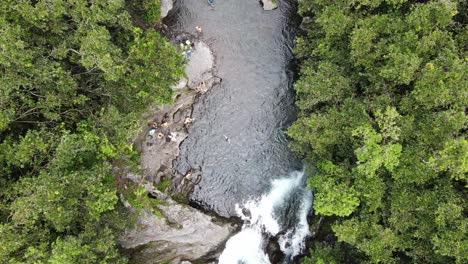 top-down drone footage of a river with people swimming at the reunion island