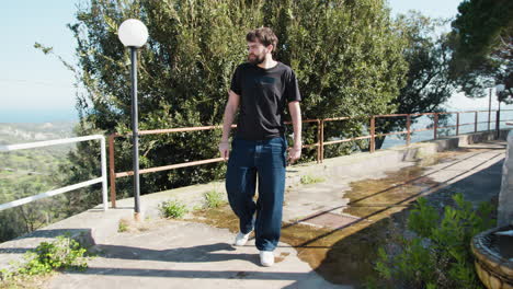 man walking on a path with a view