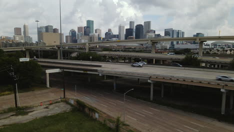 Aerial-Rising-Up-Over-Highways-to-Reveal-Houston-Skyline-—-Texas,-USA