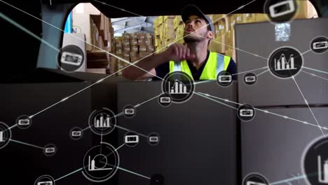 Animation-of-connected-phone-and-graph-icons,-caucasian-delivery-man-loading-boxes-in-van