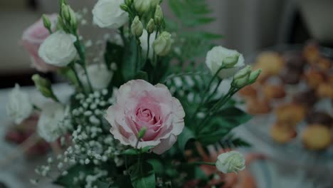 close-up of a pink rose and other flowers in a bouquet