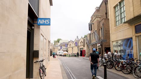 man walking past bicycles on a street