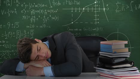 man sleeping on desk next to books in front of moving maths calculations on chalkboard