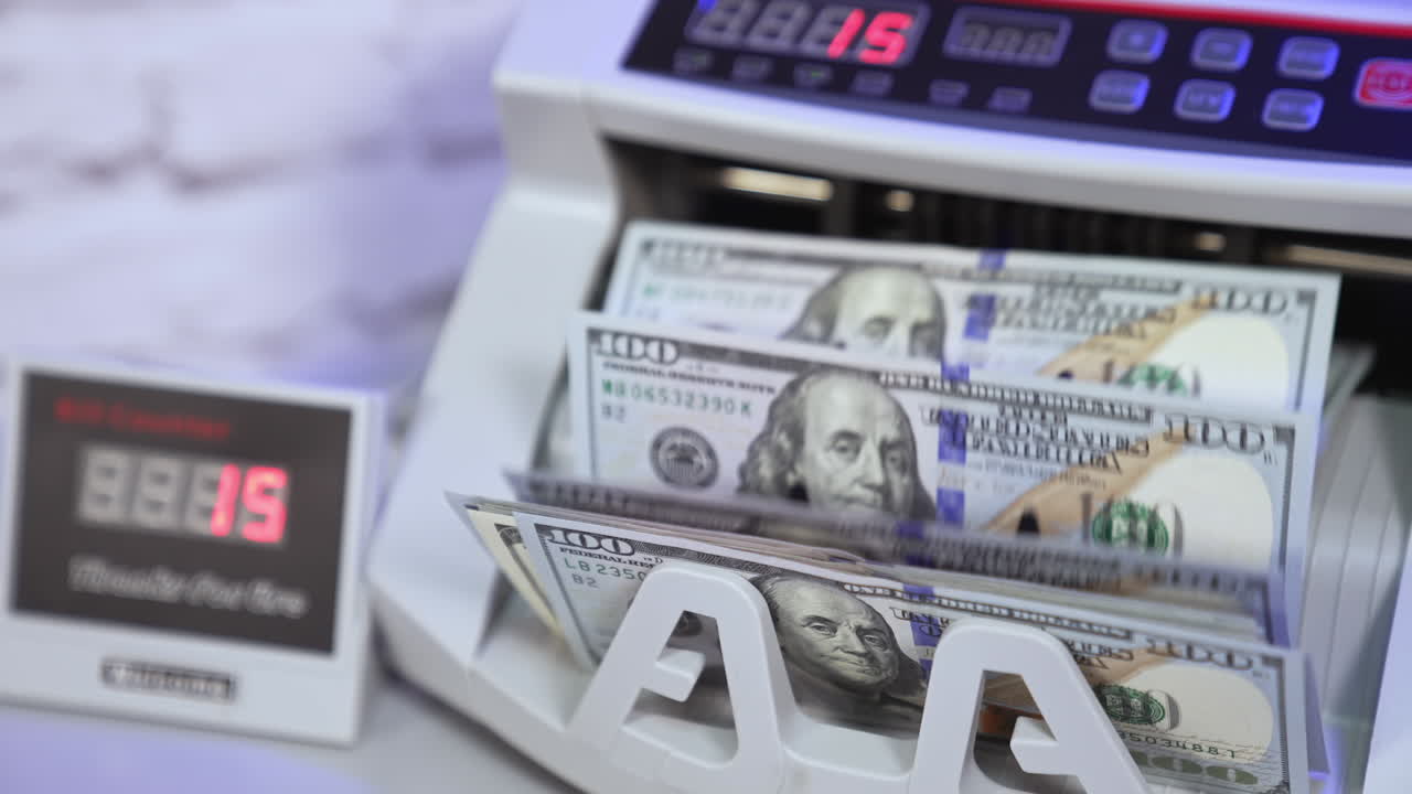 Money and business. Money counting on special machine. Banking modern counter with dollars concept. Cropped view