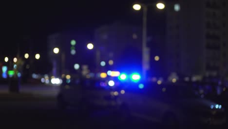 police blue lights at night and parking lot with few cars, blurry view of traffic accident symbolism