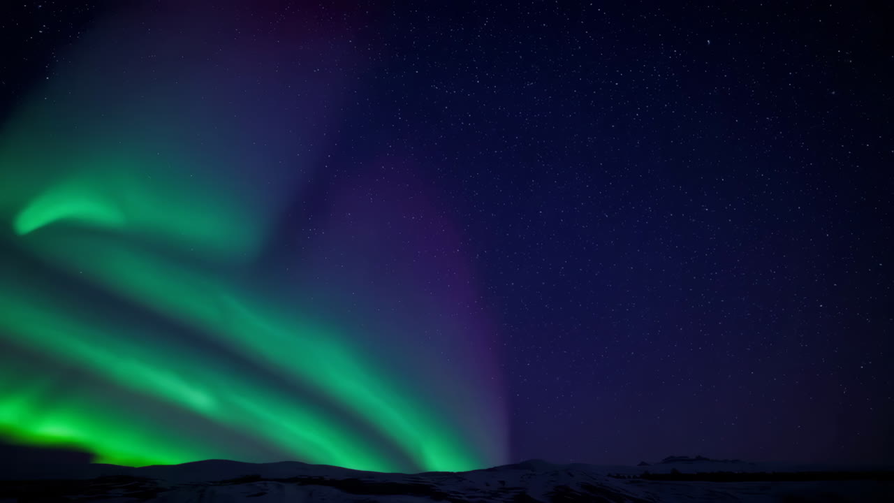 Vibrant Green Aurora Borealis Dancing Across a Starry Night Sky