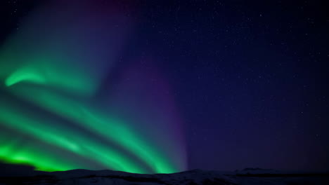 vibrant green aurora borealis dancing across a starry night sky