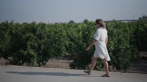woman walking through an orchard