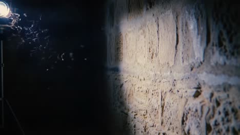 illuminated wall in dark space: exploring the textured surface and light reflection in a dimly lit environment with subtle motion elements