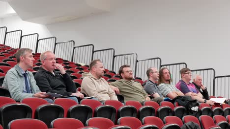 male friendships, audience group members, auditorium scenery