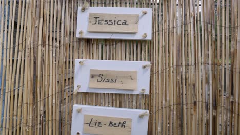 Wooden-plaques-bearing-names-are-elegantly-mounted-on-the-walls-of-a-wooden-raft,-creating-a-rustic-charm-that-blends-harmoniously-with-the-sturdy-oak-paneling