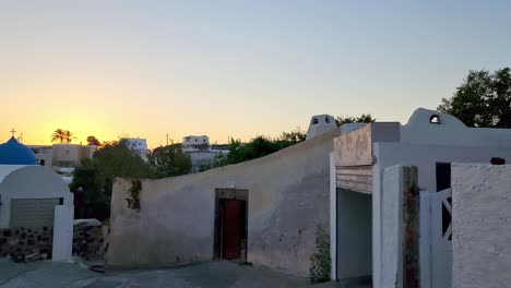 caminando por el callejón del pueblo durante la puesta de sol en una calle griega