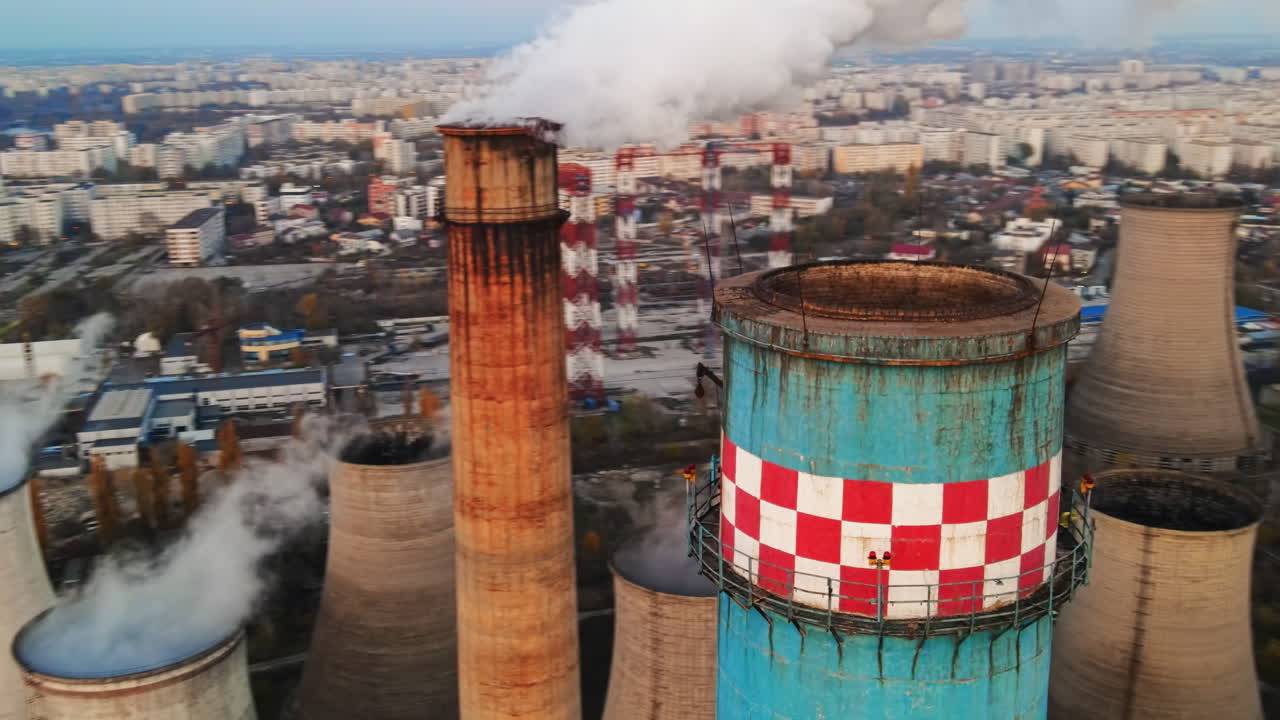 Power station with a lot of tubes and facilities in Bucharest at sunset, a lot of foam from inside a tube. cityscape, view from the drone, Romania