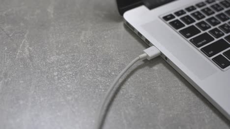 hand connecting usb hard drive to laptop, modern personal computer technology