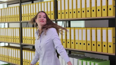 woman in office with binders