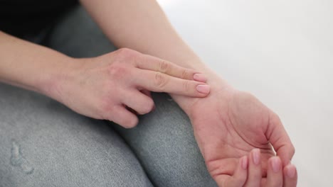 person checking their pulse on their wrist