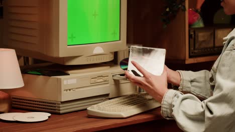 Person using a vintage computer with green screen