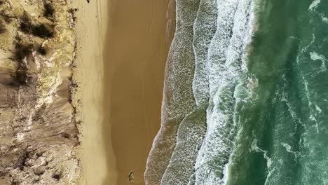 flying above sand dunes and white sandy beach during rising tide