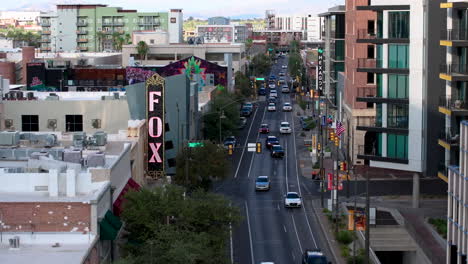 A-4k-aerial-drone-shot-slowly-moving-down-a-street-in-downtown-Tucson,-AZ-revealing-traffic,-local-stores-and-the-famous-Fox-Theater