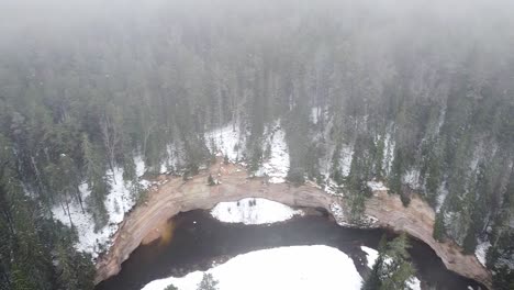 Rotating-aerial-drone-view-of-Suur-Taevaskoda-outcrop-in-Southern-Estonia-at-winter