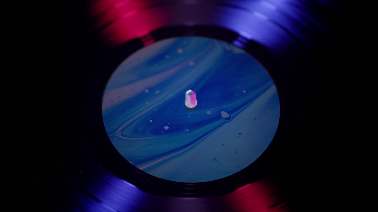 Close-up of Spinning Vinyl Record with Blue and Red Neon Lights