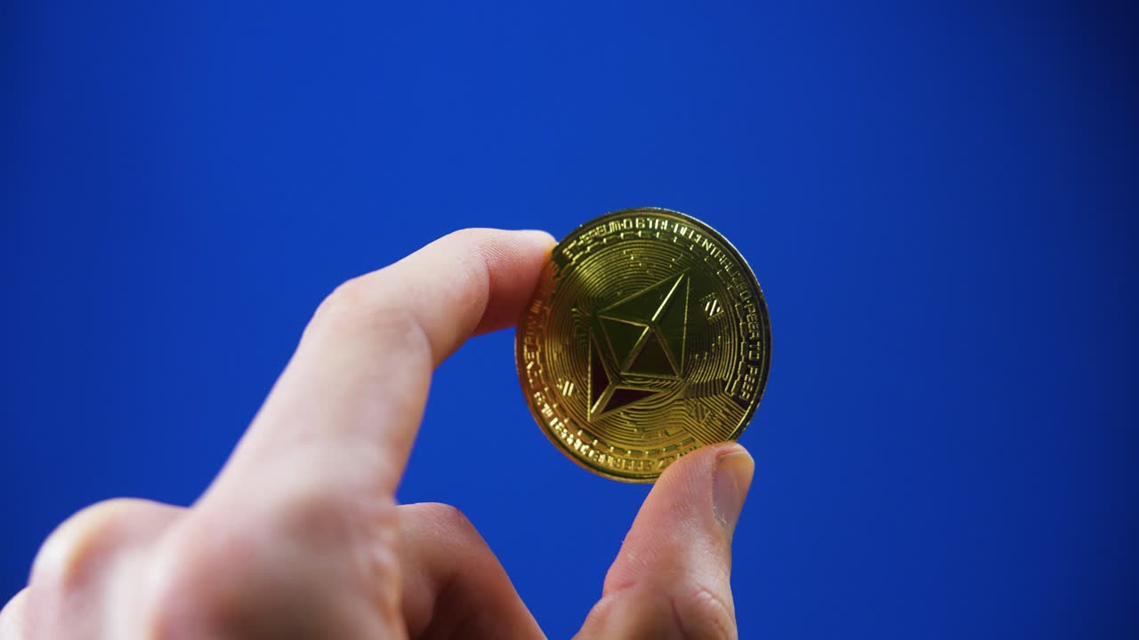 business investor hand holding a crypto coins cryptocurrency digital currency ethereum investment concept blue studio background